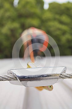 Defocused of construction worker using fall restraint protection lanyard device  clipping into horizontal steel cable system