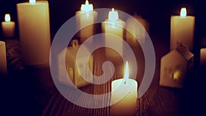 Defocused glowing candles and blinking decorative houses