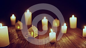 Defocused glowing candles and blinking decorative houses