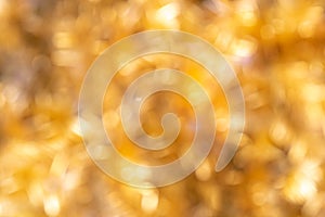 Defocused Golden Christmas Bokeh Background. Gold Holiday glowing Abstract Glitter