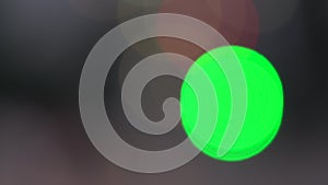 Defocused green circles light effects, abstract blurred motion boche particles