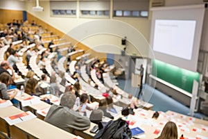 Defocused image of audience at the conference hall during academic lecture.