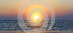 Defocused  image of beautiful sunrise above sea water, horizontal banner. Sea, landscapes concept.