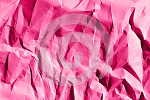 Defocused image of crumpled paper, pink colors, horizontal view.