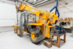 Defocused image of earth mover at factory