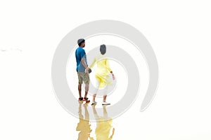 Defocused image of an Indian couple holding hands walking romantic on beach on vacation travel holidays leaving footprints in the