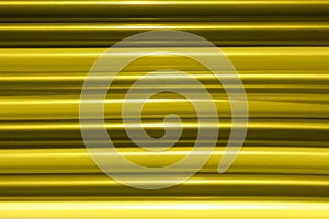 Defocused image of striped yellow texture background.