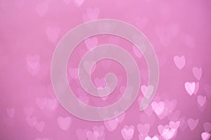 Defocused lights bokeh background of pink hearts