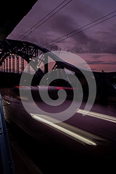 Defocused Lights of cars at night in Krakow bridge. Street line lights. Night highway city. Long exposure photograph