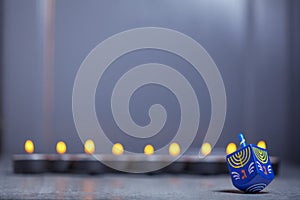 Defocused lights of Jewish holiday Hanukkah and spinning top