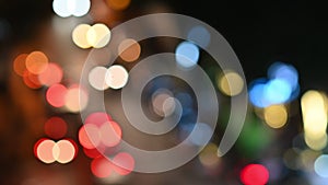 Defocused lights of vehicles traveling on road at night