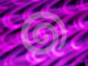 defocused neon purple lighting len flare with hook-like pattern background in low shutter speed condition can use for overlay