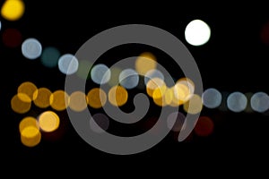 Defocused of photo bokeh blurred circle light from colorful neon lighting bulb in the night for abstract background