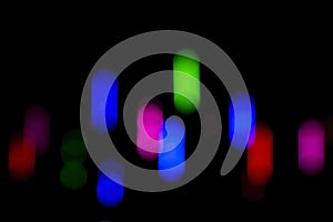 Defocused of photo bokeh blurred circle light from colorful neon lighting bulb in the night for abstract background