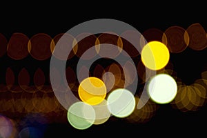 Defocused of photo bokeh blurred circle light from colorful neon lighting bulb in the night for abstract background