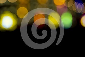 Defocused of photo bokeh blurred circle light from colorful neon lighting bulb in the night for abstract background