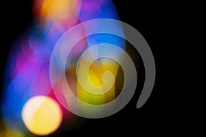 Defocused of photo bokeh blurred circle light from colorful neon lighting bulb in the night for abstract background