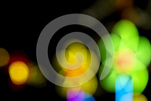 Defocused of photo bokeh blurred circle light from colorful neon lighting bulb in the night for abstract background