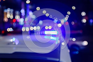 defocused photo of police car lights in night city with selective focus and bokeh