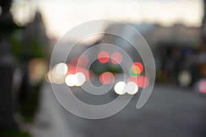 Defocused receding city traffic in the evening. Out of focus lights of traffic jam on city street. City blur background. Moving