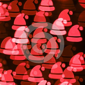 Defocused red bokeh background with red Santa`s hats