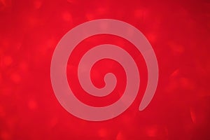 Defocused red glitter background. Abstract red defocus light