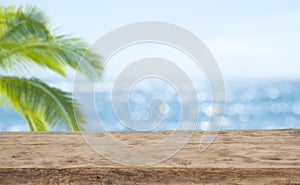 Defocused sea background with wooden table foreground for product display