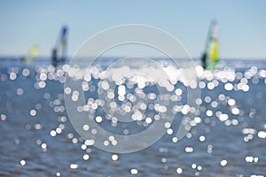 Defocused seascape with windsurfers on sea surface