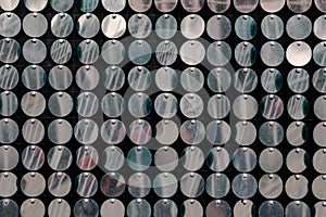 A defocused shot of repeating metallic shiny circles. A multitud photo