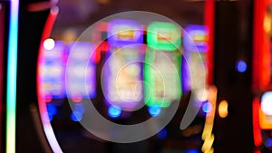 Defocused slot machines glow in casino on fabulous Las Vegas Strip, USA. Blurred gambling jackpot slots in hotel near