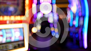 Defocused slot machines glow in casino on fabulous Las Vegas Strip, USA. Blurred gambling jackpot slots in hotel near