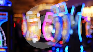Defocused slot machines glow in casino on fabulous Las Vegas Strip, USA. Blurred gambling jackpot slots in hotel near