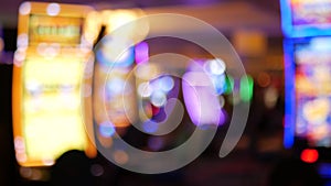 Defocused slot machines glow in casino on fabulous Las Vegas Strip, USA. Blurred gambling jackpot slots in hotel near