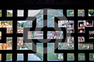 Defocused stilted wooden Diaojiao houses in Fenghuang