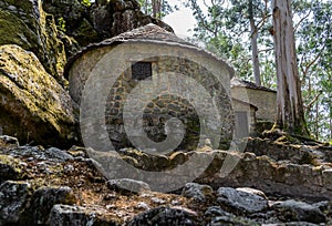 Defocused stone wall next to old reconstructed houses in Castro de SÃÂ£o LourenÃÂ§o, Vila ChÃÂ£ - Esposende PORTUGAL photo