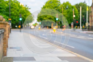 Defocused urban street background with traffic control lights at intersection