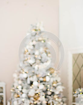 Defocused view. Beautiful Christmas tree with lights against white background
