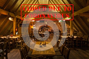 Defocused view of interior of traditional bar or restaurant, empty and closed due to coronavirus photo