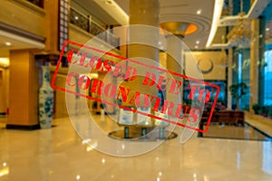 Defocused view of interior of an upmarket hotel reception, empty and closed due to coronavirus