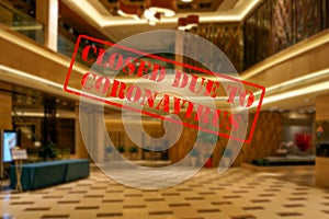 Defocused view of interior of an upmarket hotel reception, empty and closed due to coronavirus