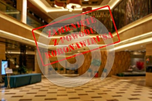 Defocused view of interior of an upmarket hotel reception, empty and closed with Polish notice Closed due to Coronavirus