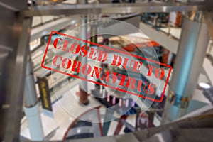 Defocused view of interior of an upmarket shopping centre, empty and closed due to coronavirus