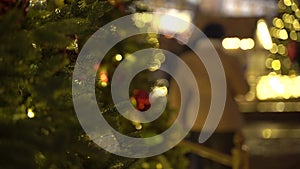 Defocused view of pedestrians walking on decorated for winter Holidays street.