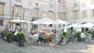 Defocused view of the traditional Italian cafe. Unidentified people eating Italian food and having conversation in an