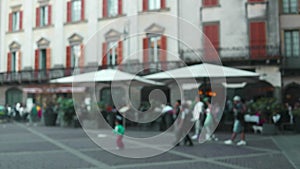 Defocused view of the traditional Italian cafe. Unidentified people eating Italian food and having conversation in an