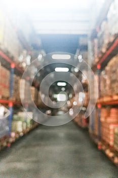 Defocused warehouse racks with cartons boxes as background