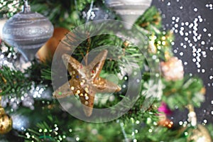 Defocusing Christmas tree festive background. Xmas decor toy balls snowflake cone sequins star snowflake.