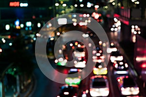 Defocussed urban traffic background at night with colourful bokeh - Blurred city congestion at road junction backdrop