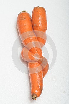 Deformed carrot on white background.