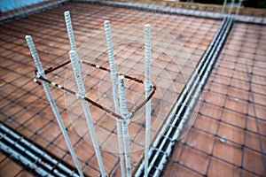 Deformed steel bars frame for beam reinforced steel footing or flooring in construction site.